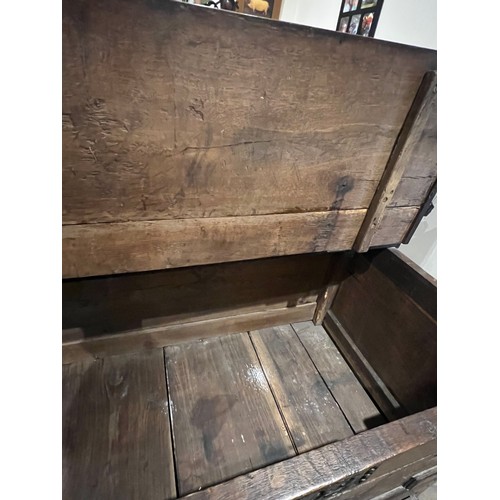 100 - An oak blanket box above four drawers with carved panels. IW 1703 carved into the top. New hinges to... 