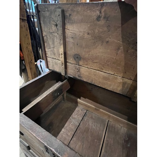 100 - An oak blanket box above four drawers with carved panels. IW 1703 carved into the top. New hinges to... 