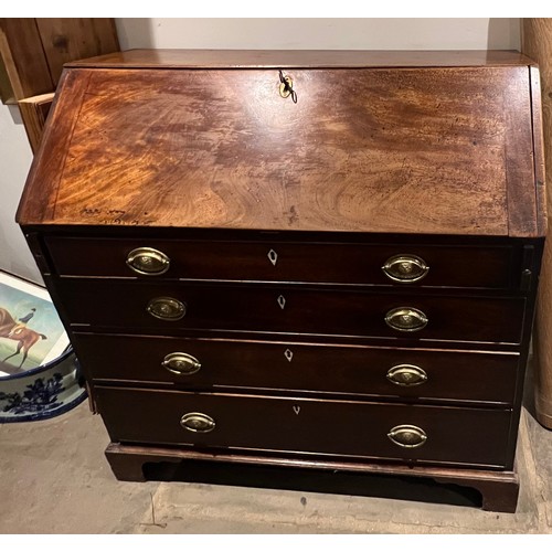 101 - A 19thC mahogany fall front bureau with well fitted interior. Four graduating drawers with ivory esc... 