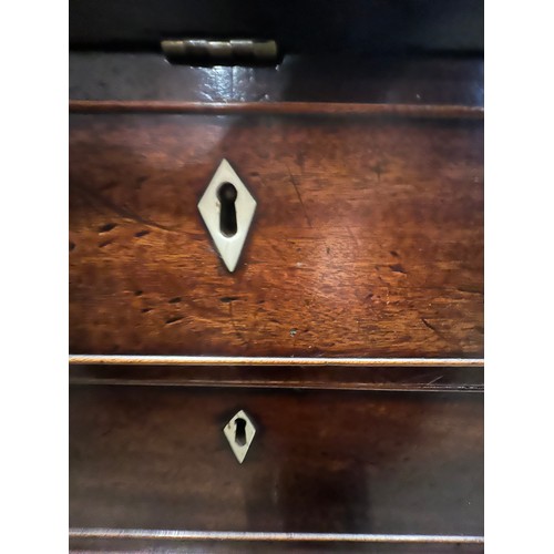 101 - A 19thC mahogany fall front bureau with well fitted interior. Four graduating drawers with ivory esc... 