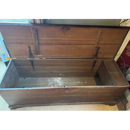 103 - A 19thC oak chest with candle box. 129cm w x 42cm d x 43cm h.