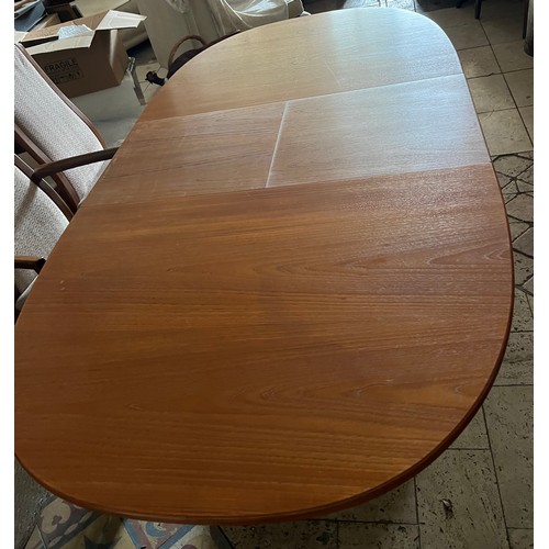 8A - An oval extending teak G-Plan dining table and 6 chairs to include 2 carvers. Closed 143 w x 101 w, ... 