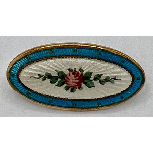 70C - An Edwardian oval enamel brooch depicting a pink rose on a white background within a turquoise borde... 