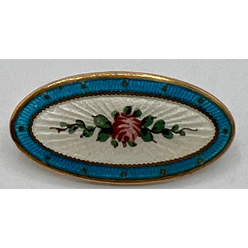 70C - An Edwardian oval enamel brooch depicting a pink rose on a white background within a turquoise borde... 