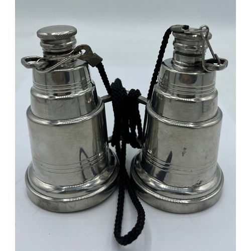 95A - A novelty pewter hip flask modelled as a pair of binoculars, each eye piece unscrewing to form two f... 