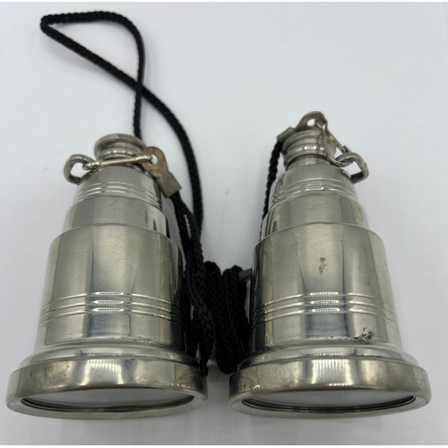 95A - A novelty pewter hip flask modelled as a pair of binoculars, each eye piece unscrewing to form two f... 