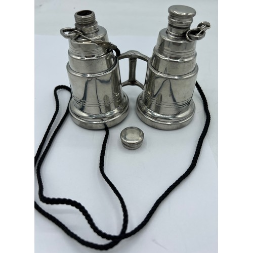 95A - A novelty pewter hip flask modelled as a pair of binoculars, each eye piece unscrewing to form two f... 