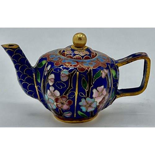 95B - A miniature cloisonn� teapot with floral decoration on blue ground. 5cm h x 8cm w.