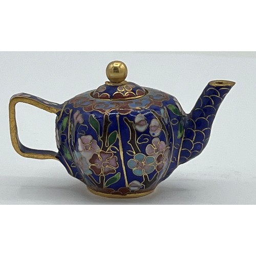 95B - A miniature cloisonn� teapot with floral decoration on blue ground. 5cm h x 8cm w.