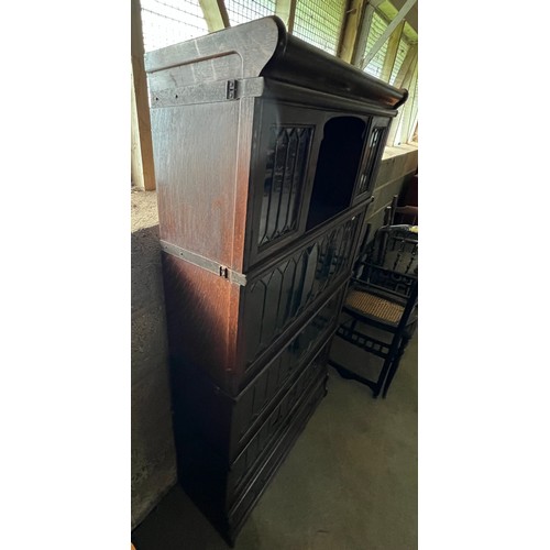 10A - A dark oak 4 height globe Wernicke and co ltd bookcase with leaded glass fronts and drawer to base 8... 