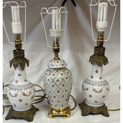 749A - Three ceramic table lamps with brass fittings, all with red shades. Two a matching pair.