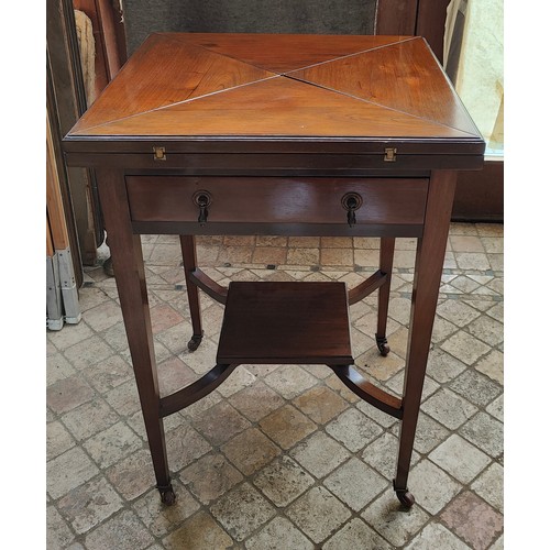 40 - An Edwardian Mahogany fold out envelope card table with draw to front and green baize and four reces... 