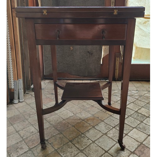 40 - An Edwardian Mahogany fold out envelope card table with draw to front and green baize and four reces... 