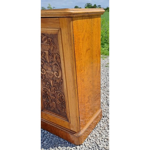 41 - A 19thC oak pot cupboard with single carved door to the front. 100cm h x 50cm w x 44cm d.