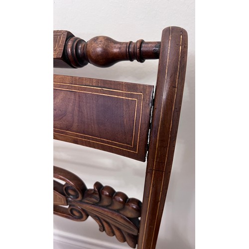 11 - A pair of regency mahogany sabre legged dining chairs.