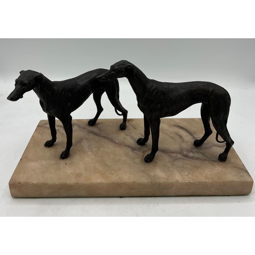 1329 - Unsigned bronze sculpture depicting two hound dogs on a marble base. 14cm h.