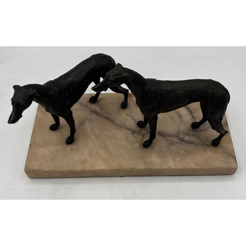 1329 - Unsigned bronze sculpture depicting two hound dogs on a marble base. 14cm h.