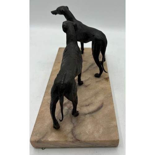 1329 - Unsigned bronze sculpture depicting two hound dogs on a marble base. 14cm h.