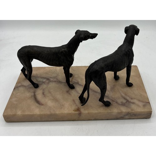 1329 - Unsigned bronze sculpture depicting two hound dogs on a marble base. 14cm h.