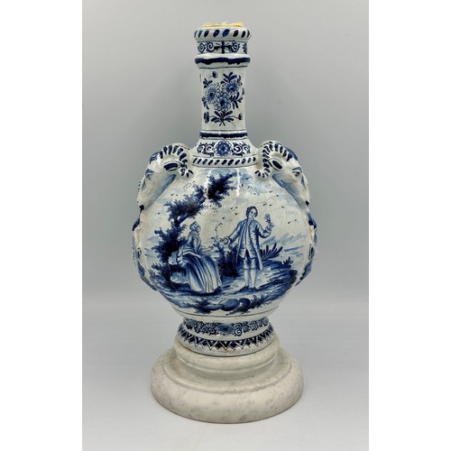 132 - A late 19th/early 20thC Dutch blue and white faience olive oil jar, 35cm h. together with a marble s... 