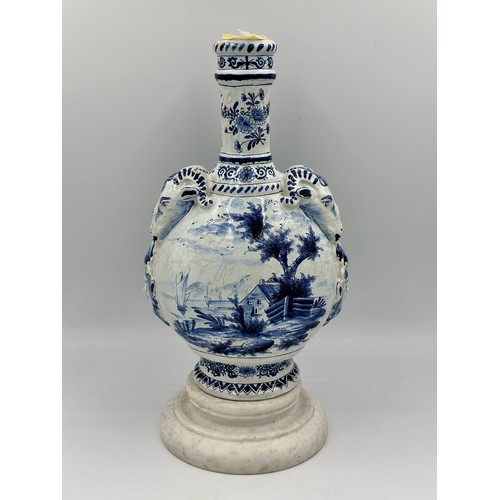 132 - A late 19th/early 20thC Dutch blue and white faience olive oil jar, 35cm h. together with a marble s... 