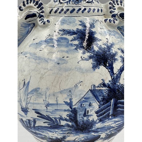 132 - A late 19th/early 20thC Dutch blue and white faience olive oil jar, 35cm h. together with a marble s... 