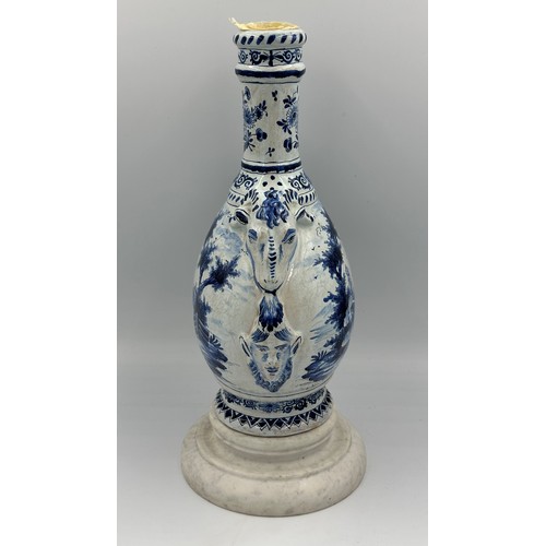 132 - A late 19th/early 20thC Dutch blue and white faience olive oil jar, 35cm h. together with a marble s... 