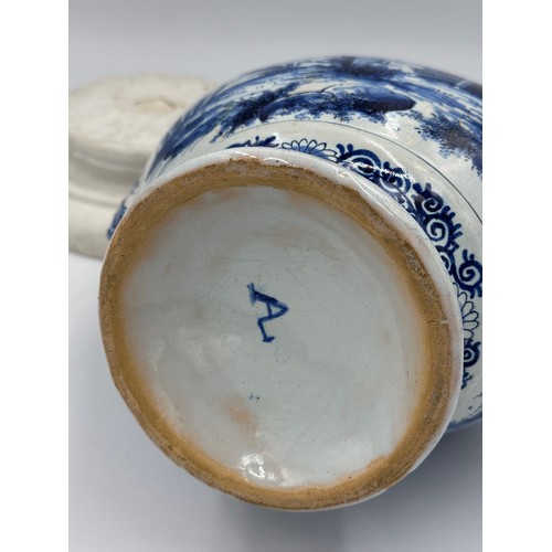 132 - A late 19th/early 20thC Dutch blue and white faience olive oil jar, 35cm h. together with a marble s... 