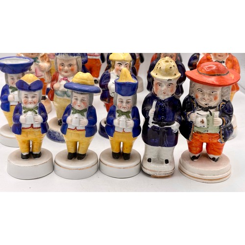 137 - An assortment of 19thC Staffordshire cruet figures, the majority holding jugs of ale. (19).