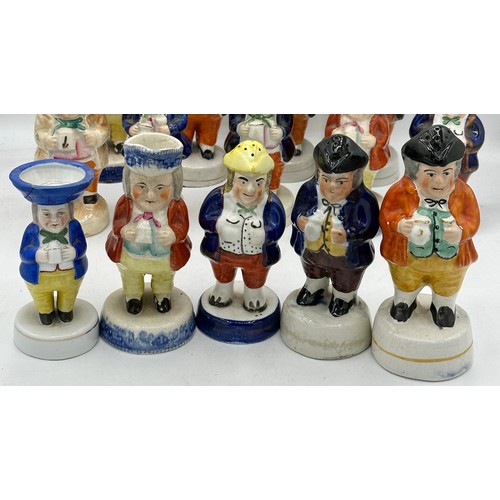 137 - An assortment of 19thC Staffordshire cruet figures, the majority holding jugs of ale. (19).