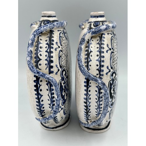 141 - A pair of 18thC Delft blue and white pottery moon flasks with applied coiled serpents to the side fi... 