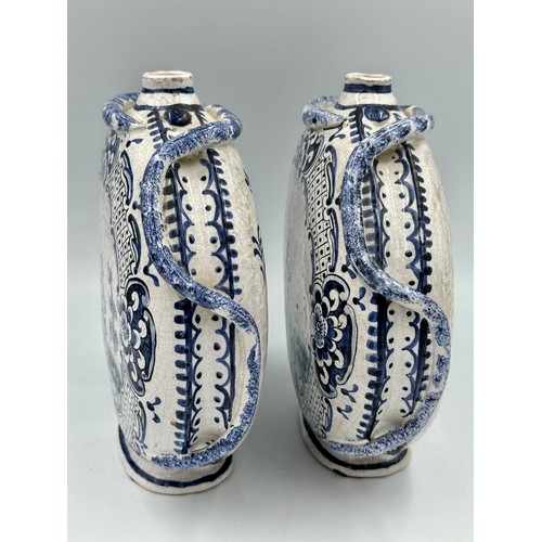 141 - A pair of 18thC Delft blue and white pottery moon flasks with applied coiled serpents to the side fi... 