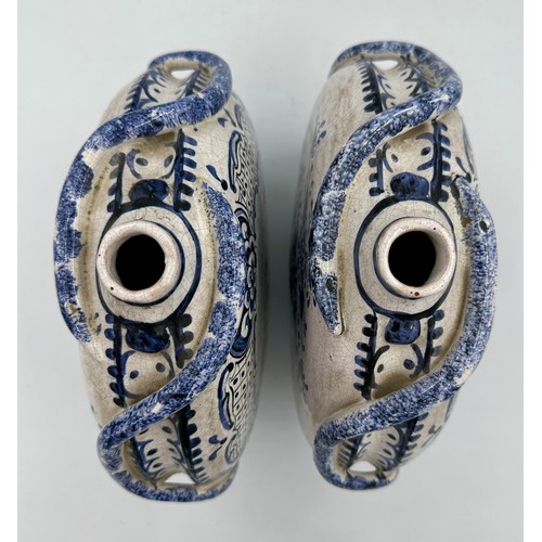 141 - A pair of 18thC Delft blue and white pottery moon flasks with applied coiled serpents to the side fi... 