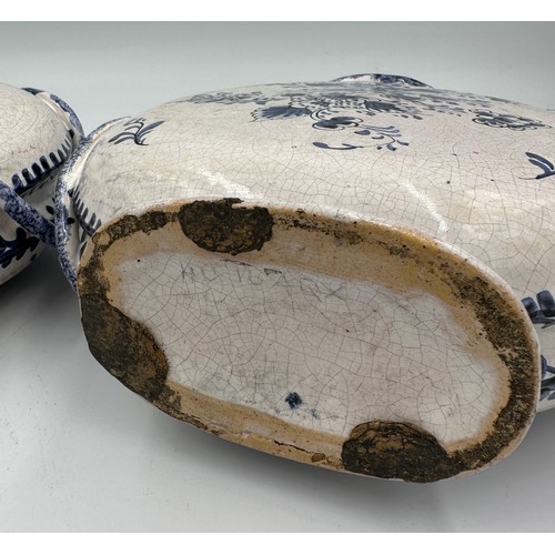 141 - A pair of 18thC Delft blue and white pottery moon flasks with applied coiled serpents to the side fi... 