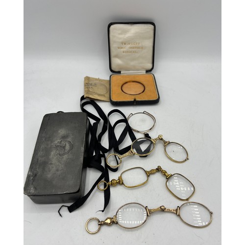 451 - Early 20thC glasses and lens contained within a 19thC pewter box with a boxed twinsight toric onepie... 