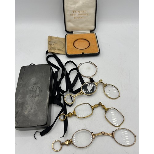 451 - Early 20thC glasses and lens contained within a 19thC pewter box with a boxed twinsight toric onepie... 