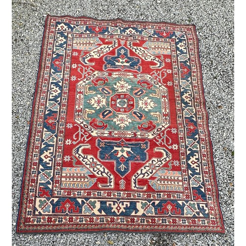 1242 - A large Caucasian rug, red, blue and cream ground. 199 x 281cm.