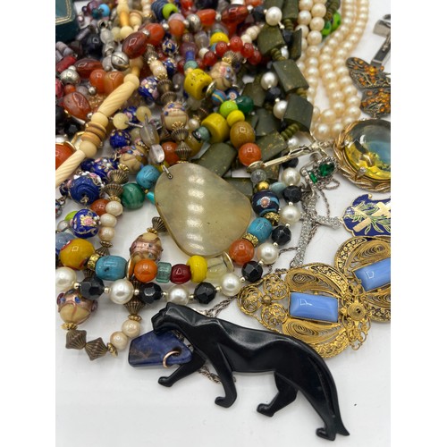 357 - A quantity of vintage costume jewellery and boxes to include glass and other beads, brooches, buckle... 