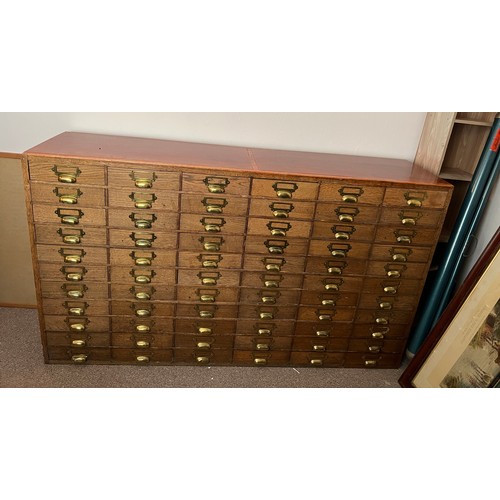 47 - A vintage oak filing cabinet with brass fittings. 149cm w x 38cm d x 86cm h.