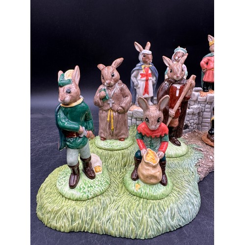 125 - A Royal Doulton Bunnykins Robin Hood collection and base, comprising of Prince John DB266, Maid Mari... 