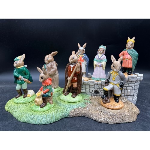 125 - A Royal Doulton Bunnykins Robin Hood collection and base, comprising of Prince John DB266, Maid Mari... 