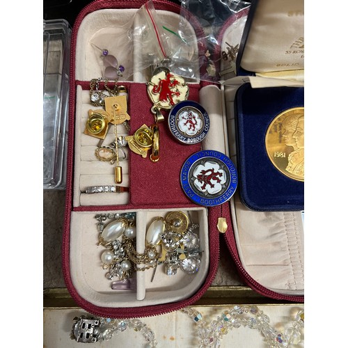 358 - A large quantity of costume jewellery to include silver, marcasite, diamanté, silver and enamel badg... 