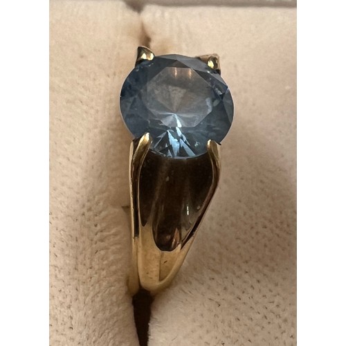 453 - A 9 carat gold ring set with blue stone. Size I/J. Weight 3.7gm.