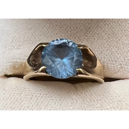 453 - A 9 carat gold ring set with blue stone. Size I/J. Weight 3.7gm.