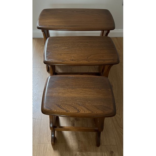 54 - A nest of three Ercol tables. Largest 57cm x 35cm x 41cm h.