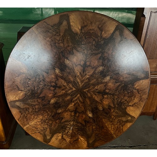 60 - A circular burr walnut dining table. 133cm d x 79cm h. The base with pull out mechanism but no extra... 