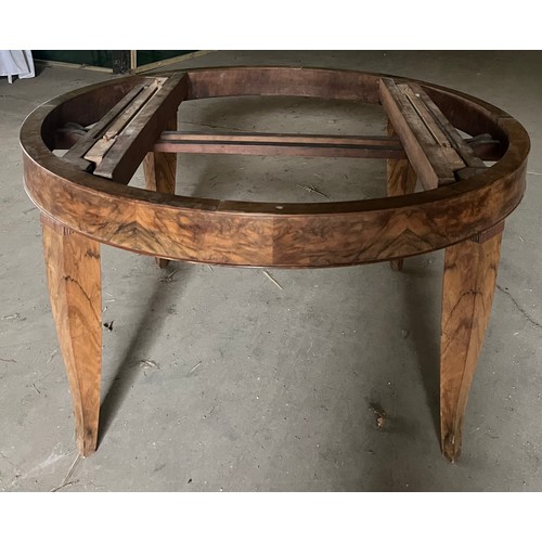 60 - A circular burr walnut dining table. 133cm d x 79cm h. The base with pull out mechanism but no extra... 