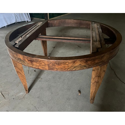 60 - A circular burr walnut dining table. 133cm d x 79cm h. The base with pull out mechanism but no extra... 