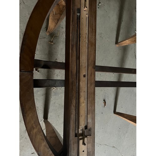 60 - A circular burr walnut dining table. 133cm d x 79cm h. The base with pull out mechanism but no extra... 