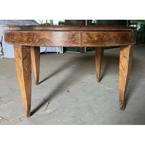 60 - A circular burr walnut dining table. 133cm d x 79cm h. The base with pull out mechanism but no extra... 